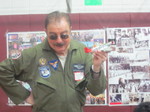 Man giving a speach to the kids in a fighter plane uniform